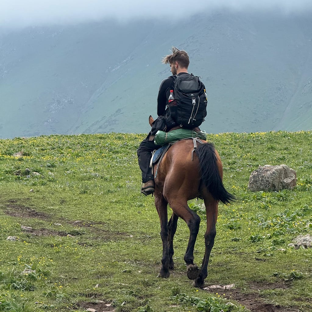 Man horse trekking to Koltor Lake