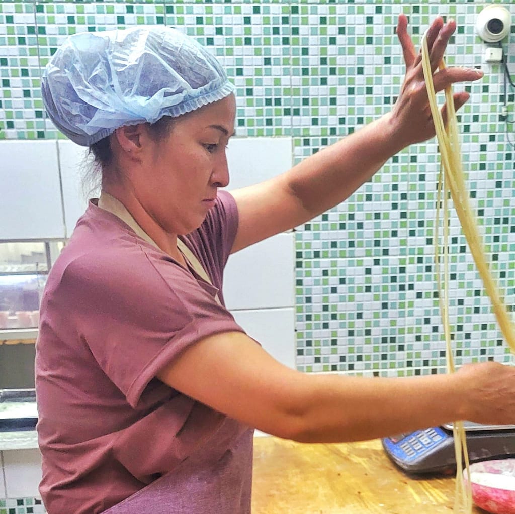 Stretching dough to make lagman noodles for kyrgyz cooking class