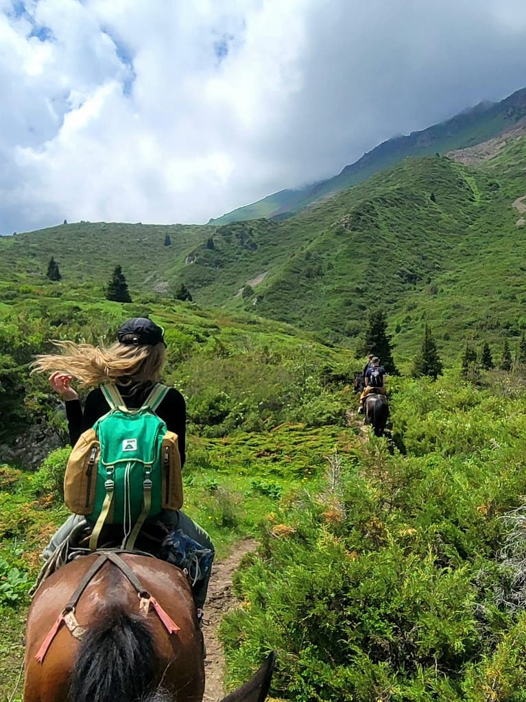 Woman horse trekking to Koltor Lake